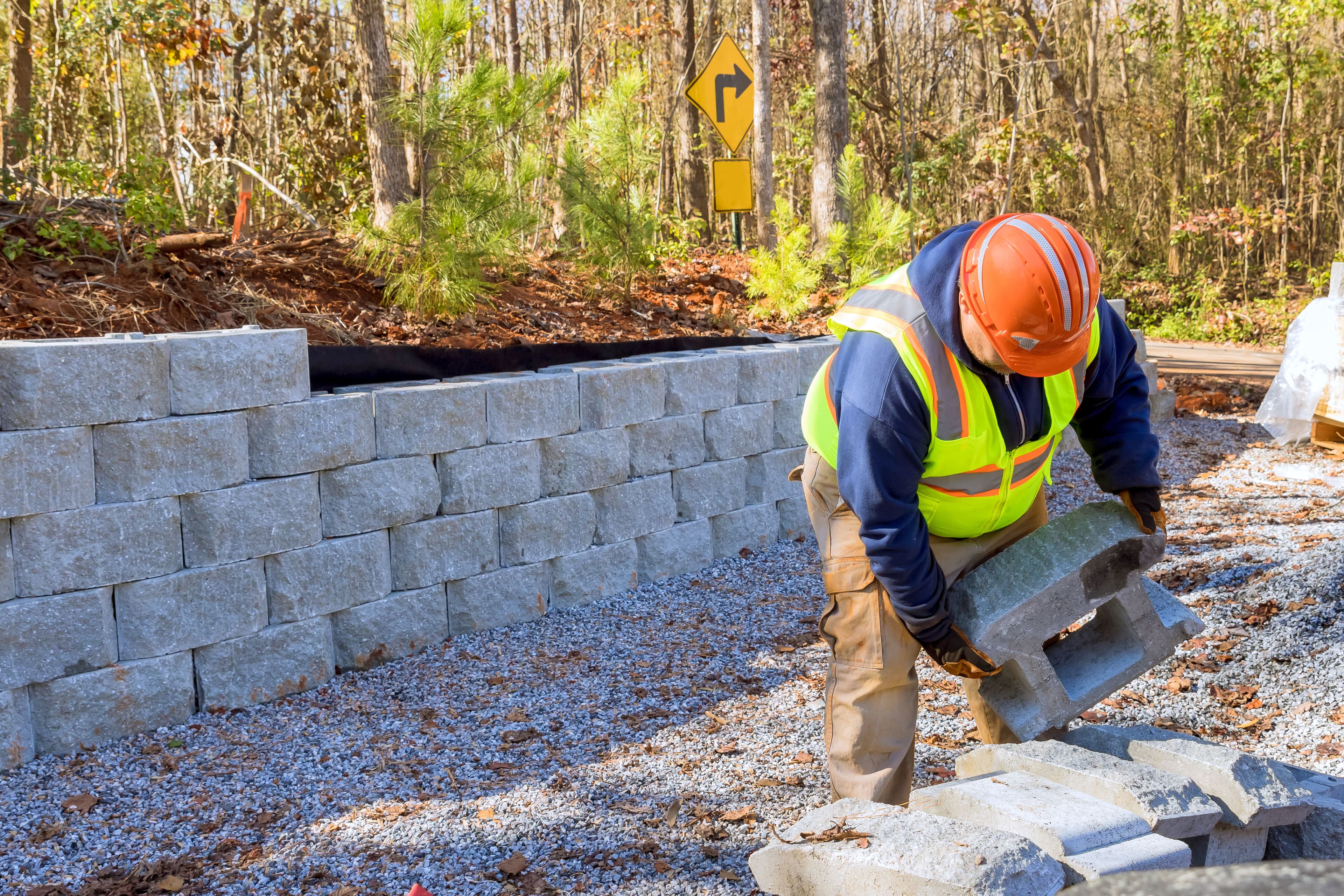 Construction worker is currently working on a retaining wall
